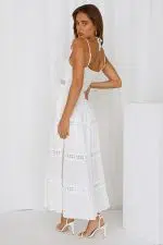 Vista trasera de una mujer luciendo un vestido de fiesta blanco